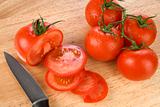 Tomatoes on wooden chopping board