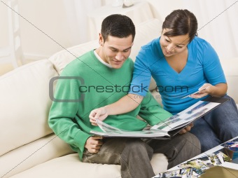 Happy Couple Viewing Photo Album