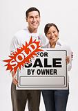 Attractive couple with sold sign