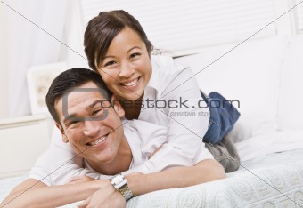 Happy Couple Posing on a Bed