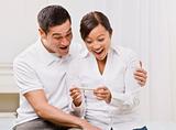 Ecstatic Couple Looking at a Pregnancy Test Together.