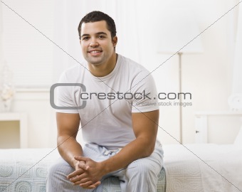 Happy Man Sitting on Bed