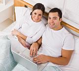Couple in Bed with Laptop