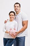 Attractive Young Couple with Piggy Bank