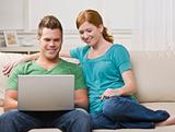 Couple Viewing Laptop Together on the Couch