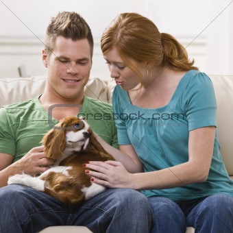 Young Couple Holding Dog