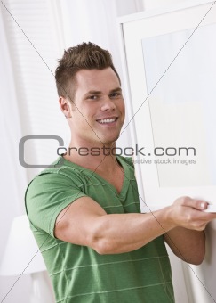 Man Hanging a Picture Frame