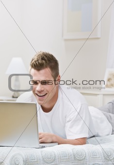Man Laughing at Laptop