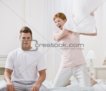 Attractive Couple Playing Around with a Pillow Fight