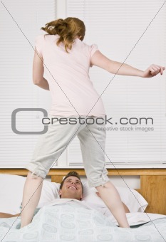 Woman dancing on bed