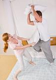 Playful Couple Having a Pillow Fight