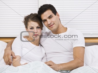 Attractive couple in bed together