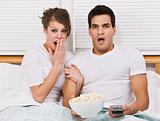 Surprised Young Couple Watching TV