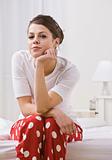 Woman on Bed Wearing Red Polka Dot Pajamas