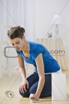 Young Woman Cleaning Water Spill