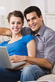Happy Couple Using Laptop