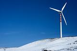 Wind turbine on snowy hill