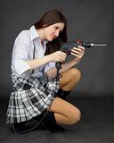 Beautiful girl in a skirt with a drill
