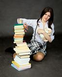 Schoolgirl with pile of books and toy dog