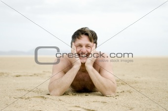 Man laying on beach.