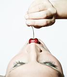Woman Tasting A Cherry In Contrast