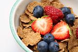 Bowl of breakfast cereal with fruit.