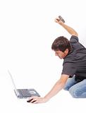 Crazy man is destroying a laptop with hammer