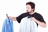 Man choosing between two shirts