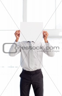 Businessman presenting a white card in front of his face