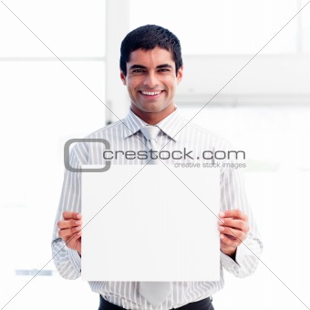 Portrait of a smiling businessman holding a white card