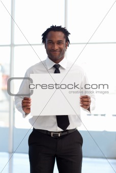 Friendly Afro-American businessman holding a white card