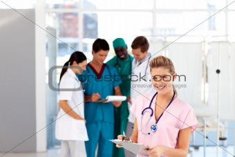 Beautiful nurse with her team in the background