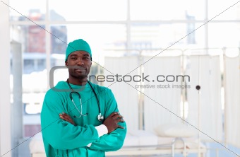Serious Afro-American surgeon with folded arms