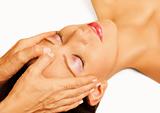 Woman lying, gets massage, reiki,acupressure on her head