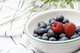 Fresh blueberries and raspberries in a bowl.