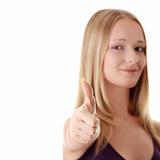 Casual woman smiling with her thumbs up - isolated