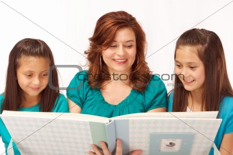 Mother showing daughters baby photo album