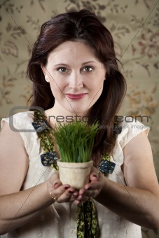 Woman with Small Pot of Green Grass