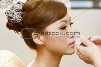 Applying makeup.