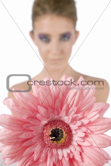 Young woman holding pink flower