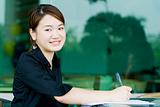 Asian business woman writing report