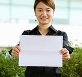 Asian business woman holding a blank paper