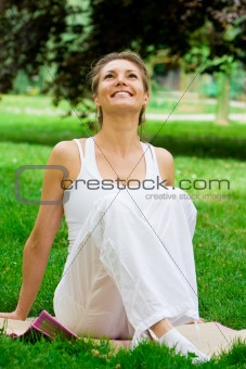 Blonde girl in park doing yoga