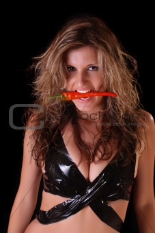 Beautiful woman with red pepper on black background