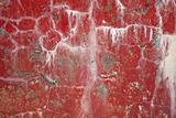 Red dirty cracked wall background with stains