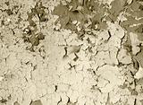 old damaged paint on a concrete wall - sepia