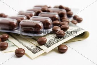 pills, dollars on a white background