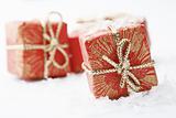 Christmas gifts with red wrapping and decorative bows.