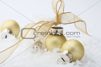 Gold Christmas bauble decorations with ribbon.