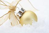 Gold Christmas bauble decoration with ribbon.